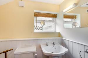 a bathroom with a sink and a toilet and a mirror at 2 Bed in Low Row oc-ds1010 in Gunnerside +26 photos