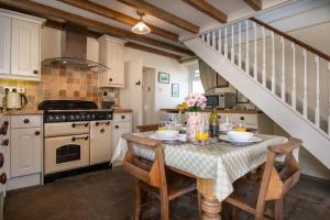 a kitchen with a table and a staircase at 2 Bed in Low Row oc-ds1010 in Gunnerside