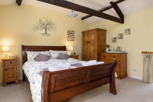 a bedroom with a large wooden bed in a room at 2 Bed in Low Row oc-ds1010 in Gunnerside