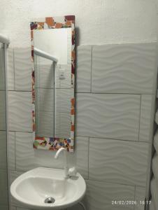a bathroom with a sink and a mirror at Suíte 2 Itaguaí in Itaguaí