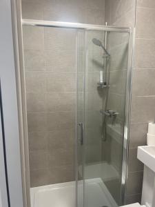 a shower with a glass door in a bathroom at Townsend lane accommodation in Liverpool +48 photos
