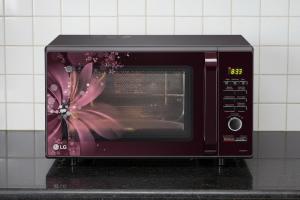 a microwave oven with a picture of a flower on it at REJOICE Homestay - 1BHK private stay in Kalyānpur