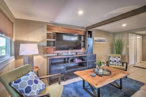 a living room with a table and a tv at Charming Lakefront Apt Near Disney in Orlando