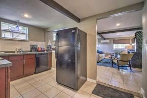 a kitchen with a stainless steel refrigerator and a living room at Charming Lakefront Apt Near Disney in Orlando