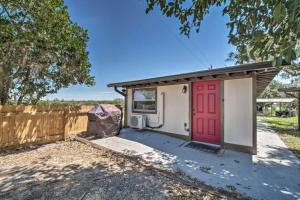 a garage with a red door and a fence at Charming Lakefront Apt Near Disney in Orlando