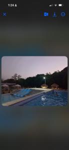a picture of a swimming pool at dusk at Skybloom Farm Resort in Balasic
