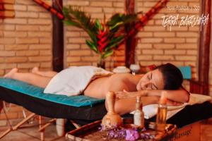 a woman laying on a bed in a room at Hotel Terra Barichara in Barichara