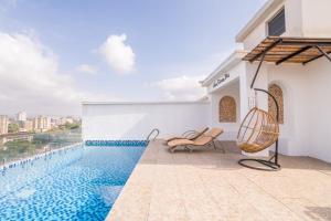 a villa with a swimming pool and two chairs at Kikao-Marina Bay in Nairobi