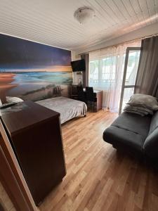a bedroom with a bed and a couch at Abba -pokoje wakacyjne in Wisła +18 photos
