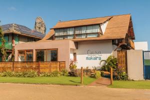 a house with a mountain in the background at Casa Makaira in Fernando de Noronha