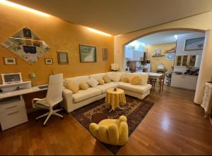 a living room with a white couch and a table at Casa Marisa in Monteviale