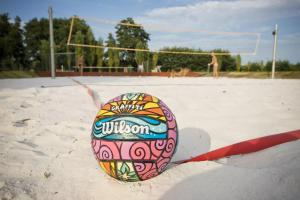 a colorful egg sitting on the sand on a volleyball court at RESORT SALIXA u Poděbrad in Poděbrady