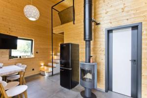 a fireplace in a room with a wooden wall at RESORT SALIXA u Poděbrad in Poděbrady +8 photos