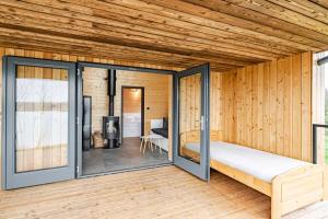 a room with a bed and sliding glass doors at RESORT SALIXA u Poděbrad in Poděbrady