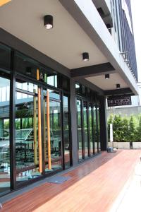 a facade of a building with large glass windows at The LogBook Room and Cafe' in Chon Buri