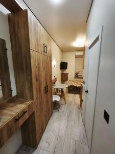 a hallway with a door and a room with a table at АппартОтель,Софія,пл Соборна in Dnipro