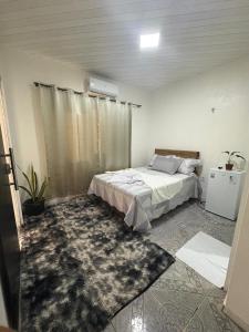 a bedroom with a bed and a rug at Hotel ph in Barcarena