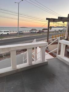 a white bench sitting on the side of a beach at Departamento 3 tecalai San Carlos, Sonora in Rancho El Pozo +5 photos