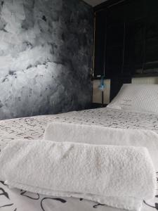 a bedroom with two white towels on a bed at Jim3 moterno studio fast wi-fi with a view in Andravída +13 photos