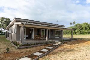 a small house with a porch at Aitutaki Holiday Villa in Arutanga