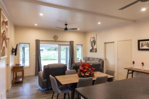 a living room with a table and chairs at Aitutaki Holiday Villa in Arutanga