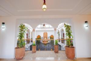 a lobby with potted plants and a fountain at Riad Dar Mima Hnina - 2 Pools, Breakfast, 10' From Jamaa el-Fna, 10' From Airport in Marrakesh +53 photos