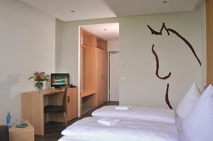 Postel nebo postele na pokoji v ubytování Reit- und Sporthotel Eibenstock