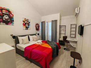 a bedroom with a bed with a colorful blanket on it at Villa Finera in Premantura