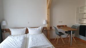 two beds in a room with a table and a desk at Südhotel in Paderborn +33 photos