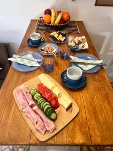 a wooden table with vegetables and meat on a cutting board at Magdalena in Cospicua +10 photos