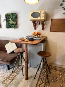 a small kitchen with a table with a microwave at Magdalena in Cospicua