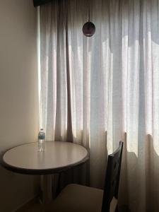 a bottle of water sitting on a table in front of a window at Hotel Ruiz Milán in Veracruz