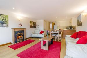 a living room with a white couch and a fireplace at 2 Bed in Smallburgh oc-h33734 in Dilham