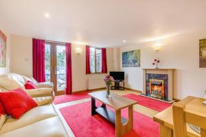 a living room with a couch and a fireplace at 2 Bed in Smallburgh oc-h33734 in Dilham