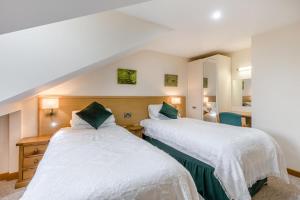 two twin beds in a room with a staircase at 2 Bed in Smallburgh oc-h33734 in Dilham +21 photos