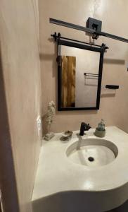 a bathroom with a white sink and a mirror at SEA Villa With Private Plunge Pool in Todos Santos