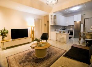 a living room with a television and a table in a room at Twins in Serres