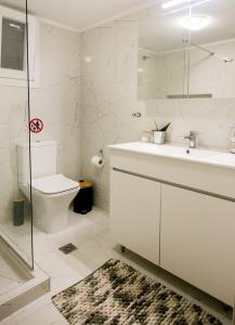 a white bathroom with a sink and a toilet at Twins in Serres +53 photos