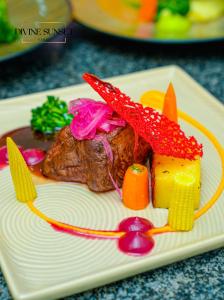 a plate of food with meat and vegetables on it at Olifile Boutique Hotel & Restaurant in Midrand