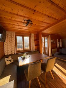 a dining room in a log cabin with a table and chairs at Moabauer in Wagrain