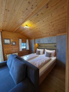 a bedroom with a large bed and a couch at Moabauer in Wagrain