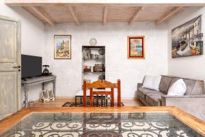 a living room with a couch and a table at Osterio Magno in Cefalù +30 photos
