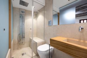 a bathroom with a toilet and a sink and a shower at Osterio Magno in Cefalù