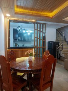 a dining room with a wooden table and chairs at Caperina del Casa-Rental in Naic