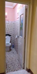 a bathroom with a toilet and a door in it at Caperina del Casa-Rental in Naic +9 photos
