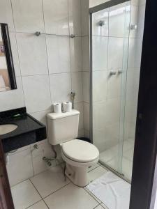 a bathroom with a toilet and a glass shower at Argentin Palace Hotel in Americana +21 photos