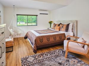 a bedroom with a bed and a chair and a window at Saddleview Bed & Breakfast in South Sterling +33 photos