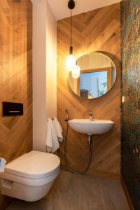 a bathroom with a sink and a toilet and a mirror at Pargi 21 Apartments in Tartu +38 photos