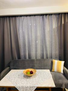 a bowl of fruit on a table in front of a couch at Downtown Studio 31 in Serres