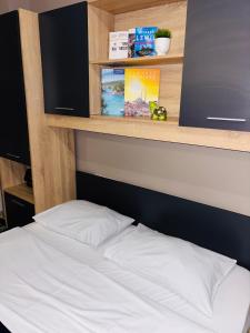 a bed with white sheets in a room at Downtown Studio 31 in Serres